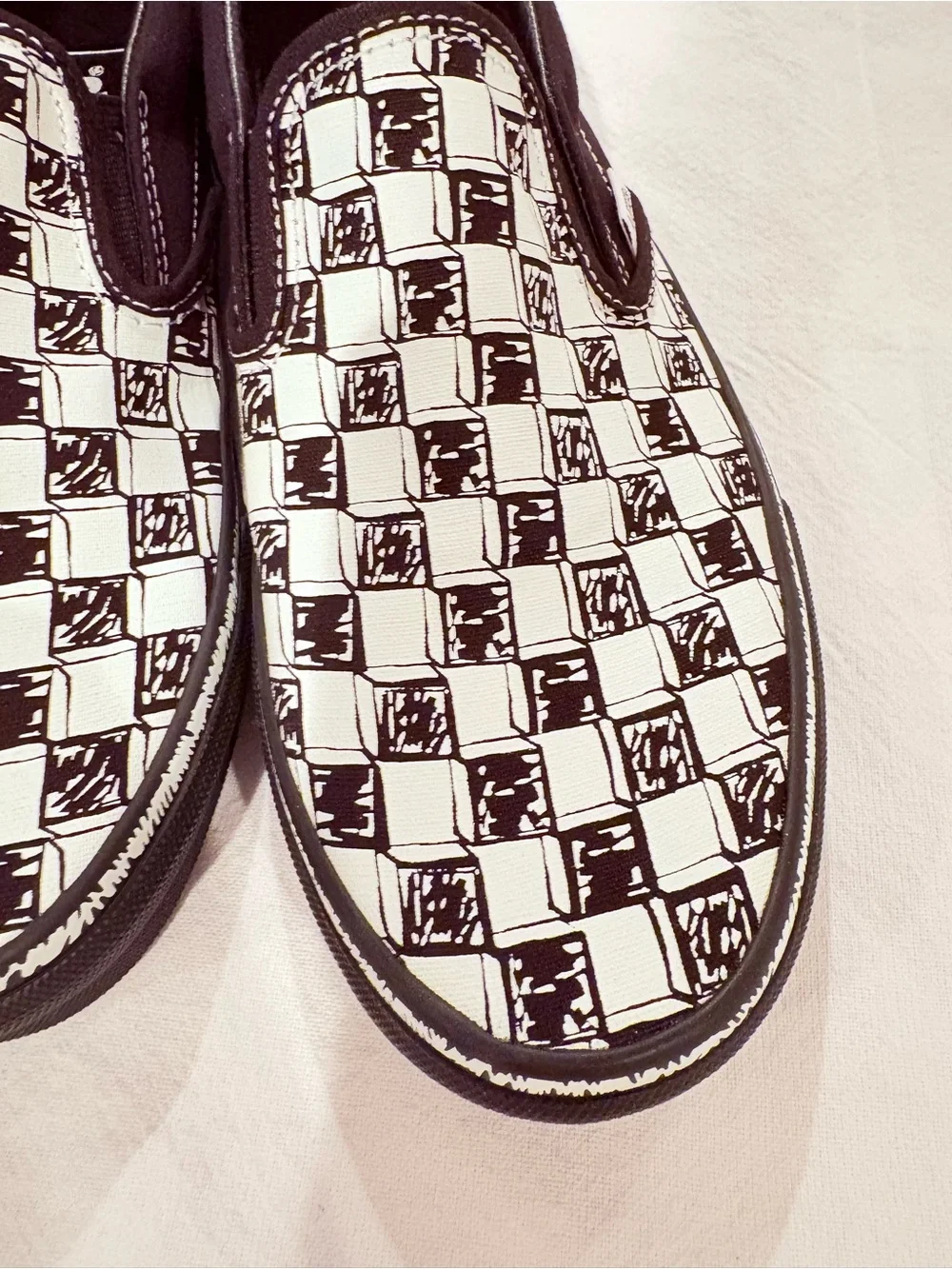 Vans Black and White Checkerboard Slip-On Sneakers